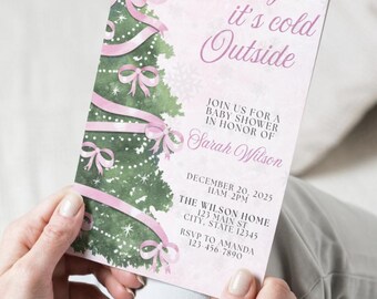 May include: A baby shower invitation with a Christmas tree design. The invitation features a pink and white color scheme with the text "Baby it's cold Outside". The invitation includes the date, time, and location.