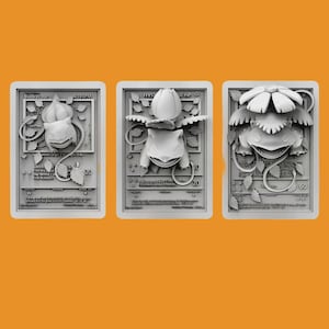 May include: Three white plastic Pokemon trading cards featuring the character Bulbasaur. The cards are in different stages of evolution, with the first card showing Bulbasaur as a small, green creature with a bulb on its back, the second card showing Bulbasaur as a larger, green creature with a larger bulb on its back, and the third card showing Bulbasaur as a fully evolved creature with a large, flower-like bulb on its back.