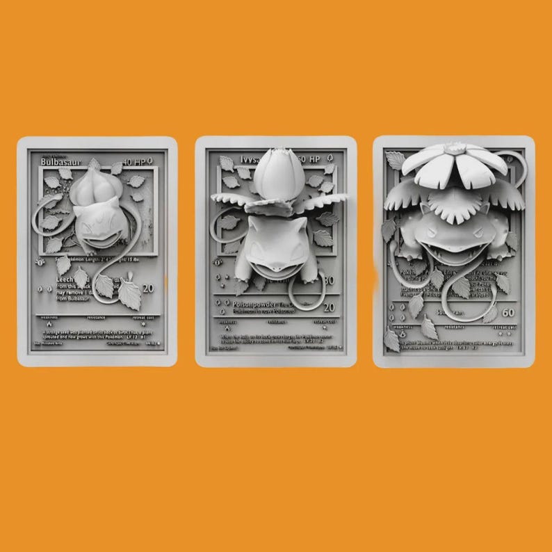 May include: Three white plastic Pokemon trading cards featuring the character Bulbasaur. The cards are in different stages of evolution, with the first card showing Bulbasaur as a small, green creature with a bulb on its back, the second card showing Bulbasaur as a larger, green creature with a larger bulb on its back, and the third card showing Bulbasaur as a fully evolved creature with a large, flower-like bulb on its back.