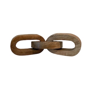 May include: A decorative chain link object crafted from natural brown wood, featuring three interlocking oval-shaped links with a visible wood grain texture. The piece is arranged horizontally, showcasing a smooth finish and solid construction.
