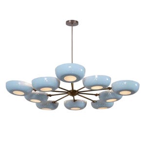 May include: A modern chandelier with a bronze finish and twelve light blue, bowl-shaped shades. Each shade has a speckled pattern and a warm white light. The fixture is suspended from a matching bronze rod.