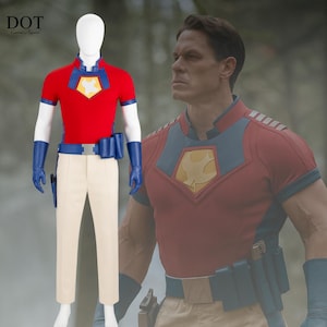 May include: A red and blue superhero costume with a yellow emblem on the chest. The costume includes a short-sleeved shirt, cream-colored pants, a blue belt, gloves, and a holster. The costume is displayed on a mannequin.