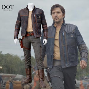 May include: A white ceramic mug with a black handle and the text "But first, coffee" in a black, handwritten-style font. The mug is on a white surface.