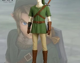 May include: A green tunic and pants costume with brown leather accents, including a belt, shoulder strap, and boots. The costume includes a green hat and a sword on the back. The text "DOT Custom Apparel" is in the upper left corner.