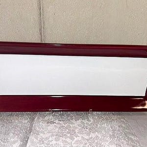 May include: Rectangular serving tray with a glossy burgundy frame and a white interior. The tray has a slightly angled design and is suitable for serving food or displaying items. The tray is made of a durable material.