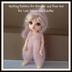 May include: A pink knitted romper and matching pixie hat for a doll. The doll has blonde hair and blue eyes. The romper has a beaded trim and the hat has a pink flower.