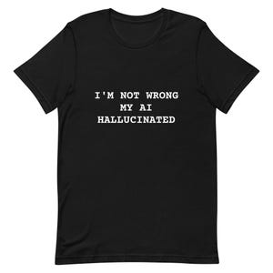 May include: Black t-shirt with the white text "I'M NOT WRONG MY AI HALLUCINATED". The short-sleeved shirt is made of a soft material and has a crew neck. The text is centered on the front of the shirt.