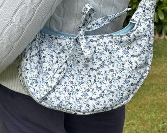 Handmade, floral shoulder bag with tie bow fastening.