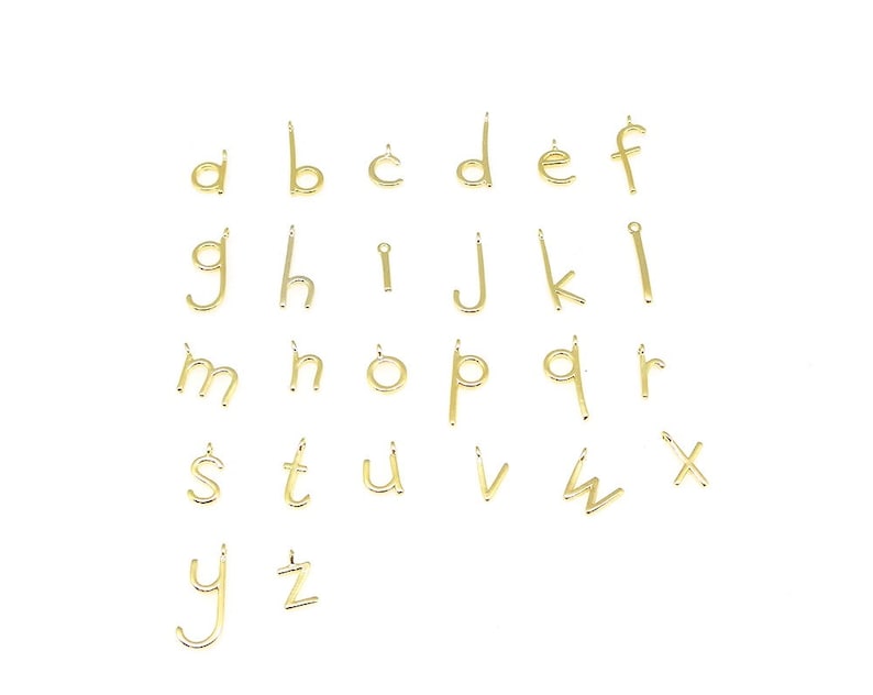 May include: Gold-toned metal alphabet letter charms. Each charm is a single letter of the alphabet, from A to Z. The charms are small and delicate, perfect for adding a personalized touch to jewelry.