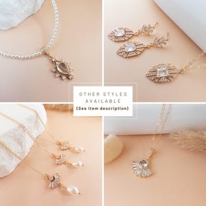 May include: A collection of gold-toned jewelry, including necklaces and earrings, with clear and pearl accents. The necklaces feature intricate pendant designs. The image includes the text "OTHER STYLES AVAILABLE (See item description)".
