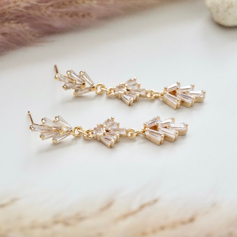 A pair of gold Art Deco earrings with fan shaped studs.