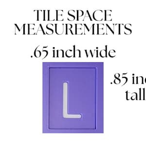 May include: A lavender tile space measurement guide with the letter "L" cut out. The text reads "TILE SPACE MEASUREMENTS .65 inch wide .85 inch tall."