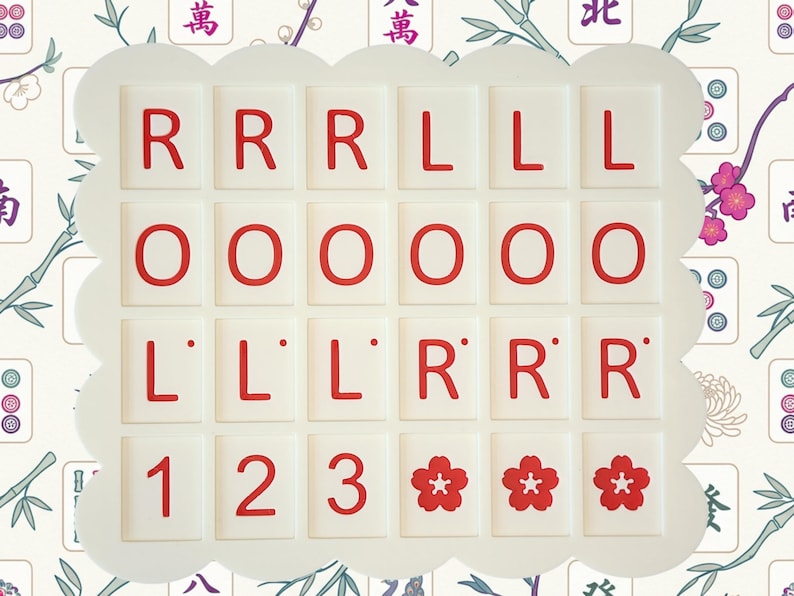 May include: A set of white Mahjong tiles with red characters and symbols, arranged in a scalloped frame. The tiles display letters, numbers, and floral designs. The background features a floral and bamboo pattern.