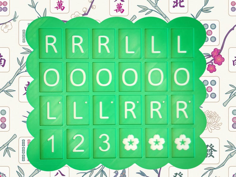 May include: A green, scalloped-edged game board with white letters and numbers. The letters spell out "RRRLLLOOOLLLRRR" and the numbers are "123". Three white flower symbols are at the bottom. The background has a floral and bamboo pattern.