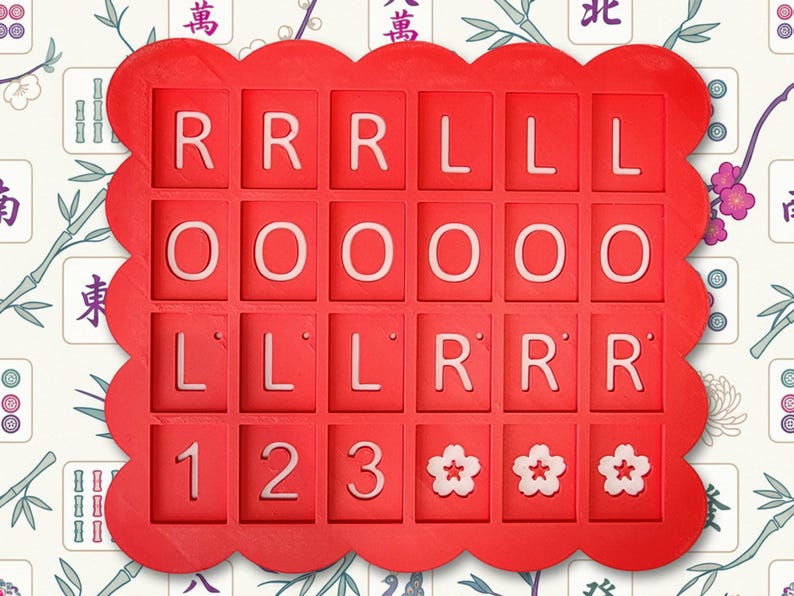 May include: A red, scalloped-edge tray with individual square compartments. Each compartment contains a white letter or number. The letters spell out "ROLL LOL" and include the numbers 1, 2, and 3, along with three flower symbols.