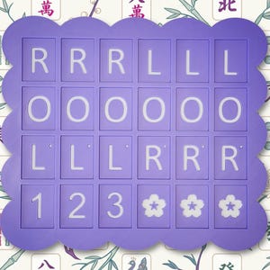 May include: A purple Mahjong tile holder with a scalloped edge. The holder contains tiles with the letters R, L, and O, numbers 1, 2, and 3, and flower symbols. The background features a floral and bamboo pattern.
