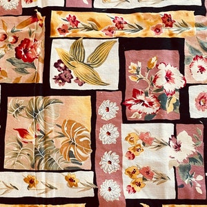 May include: A floral fabric with a repeating pattern of squares and rectangles. The design features hibiscus, daisies, and tropical leaves in shades of red, pink, yellow, and cream, set against a dark brown background.