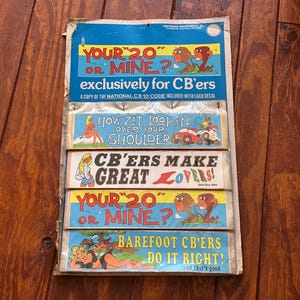 May include: A vintage cardboard display card featuring five colorful bumper stickers with cartoon illustrations and text including YOUR 20 OR MINE, HOW ZIT LOOKIN OVER YOUR SHOULDER, CB'ERS MAKE GREAT LOVERS, and BAREFOOT CB'ERS DO IT RIGHT.