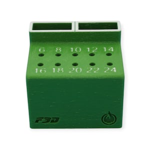 May include: A green 3D-printed tool holder with two rectangular compartments on top and numbered holes on the front. Numbers range from 6 to 24. The holder has the text "F3D" and a circular logo on the front.