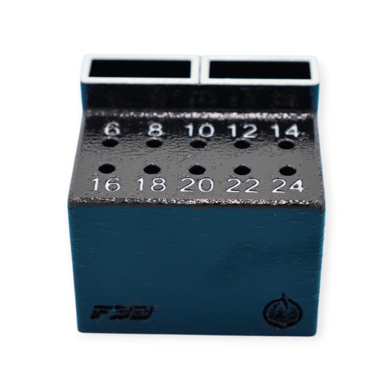 May include: A dark blue tool holder with multiple holes and numbered markings. The top section has two rectangular openings. Numbers 6 through 24 are visible, indicating sizes. The base has Japanese text and a logo.