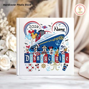 May include: White hardcover photo book with a colorful Disney cruise design. The cover features a cruise ship, Disney characters, balloons, and the text "Disneycruise" and "2026". The book is decorated with nautical elements.