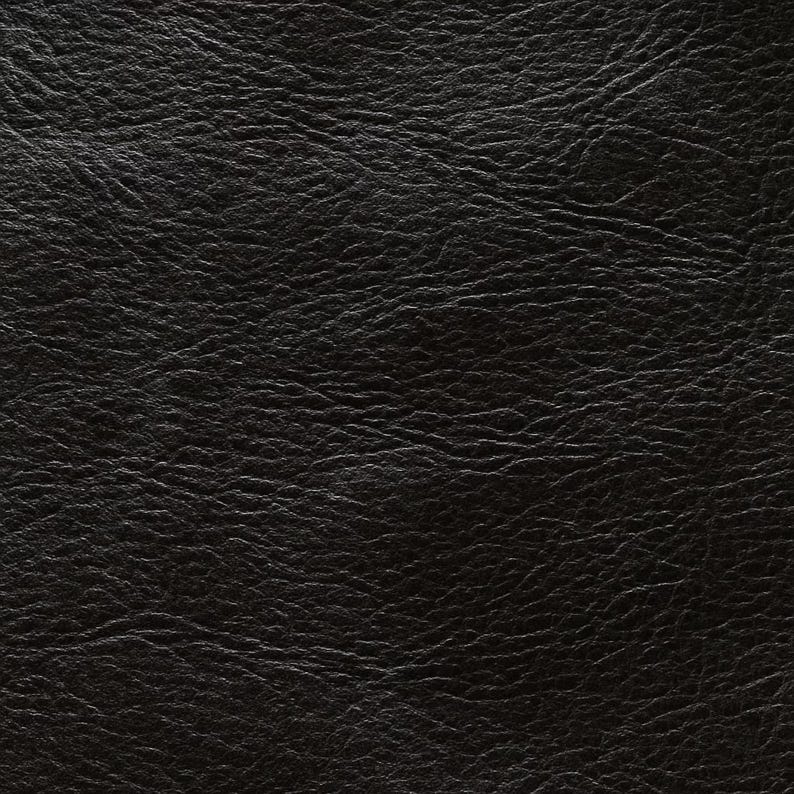 May include: Close-up of a textured black leather surface. The leather has a slightly glossy finish and a pattern of fine wrinkles and subtle variations in tone, creating a rich, detailed appearance. The overall effect is one of depth and sophistication.