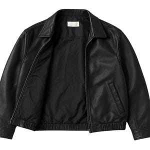 May include: Black leather jacket with a collared neckline and a zipper closure. The jacket has two front pockets and a ribbed hem. The interior lining is black. A classic outerwear piece.