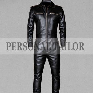 May include: A black leather jumpsuit with a collared neckline, long sleeves, and a front zipper closure. The jumpsuit features multiple zippered pockets and a tailored fit. The text "PERSONAL TAILOR" is visible across the midsection.