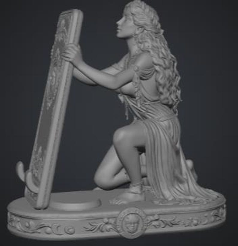 May include: A monochromatic gray resin sculpture of a figure with long flowing hair kneeling on an oval base. The figure holds a tall rectangular frame with ornate carvings. The base features a central circular emblem with a face relief.