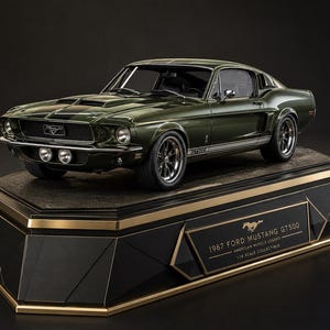 May include: A dark green 1967 Ford Mustang GT500 model car with black racing stripes, chrome wheels, and dual front fog lights. The vehicle is mounted on a black and gold display base featuring the text 1967 FORD MUSTANG GT500 AMERICAN MUSCLE LEGEND 1:18 SCALE COLLECTIBLE.