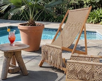 May include: A wooden lounge chair and a matching footstool featuring intricate beige macrame cord weaving with long fringe details. The chair has a reclining frame and the footstool is rectangular, both showcasing a consistent knotted pattern.