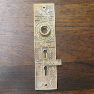 May include: A white ceramic mug with a black handle and the text "But First, Coffee" in a black, bold font. The mug is on a white surface. The mug is 10 cm tall.