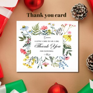 May include: A white thank you card with a floral border featuring pink, yellow, and blue flowers. The card includes the text "Thank You" and "for everything". The card is surrounded by holiday decorations.