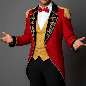 May include: A red tailcoat with black velvet lapels and gold trim, featuring gold epaulets and decorative gold embroidery. The coat is paired with a gold vest and a red bow tie, creating a theatrical look.