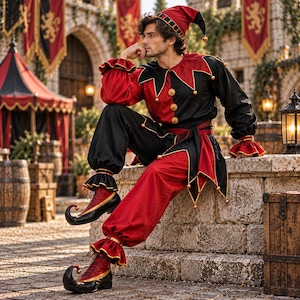 May include: A jester costume featuring a red and black color-blocked long-sleeve tunic with a pointed collar, matching trousers with ruffled cuffs, a pointed hat with bells, and curled-toe boots with red and black panels and gold trim accents.