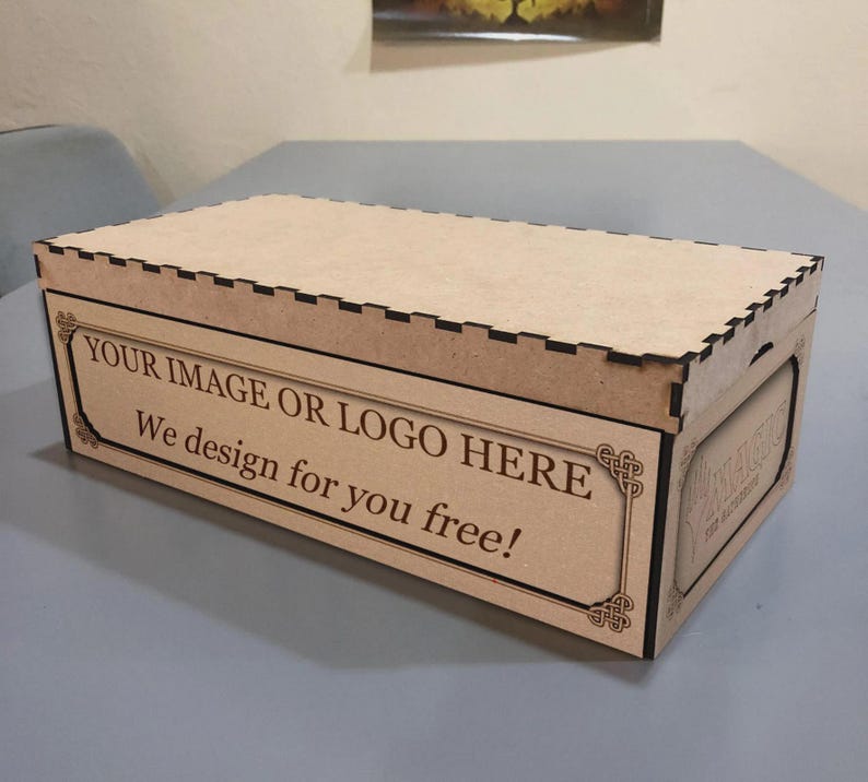 A wooden box with a lid, sitting on a table. The box has a message that says "YOUR IMAGE OR LOGO HERE We design for you free!"