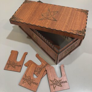 a wooden box with a lid and several wooden cards or pieces with the same design.