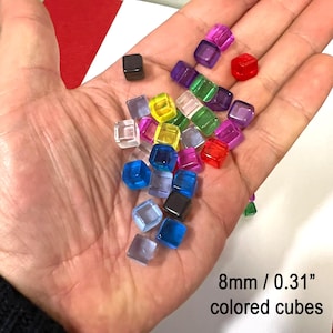 May include: A selection of colourful, transparent cubes, each measuring 8mm. The cubes are in various colours, including red, purple, green, yellow, blue, and clear. The image text reads "8mm / 0.31" coloured cubes."