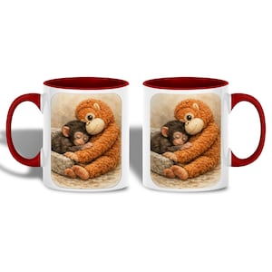 May include: White ceramic mug with a maroon interior and handle. The mug features a heartwarming illustration of two monkeys cuddling. One is brown and the other is black, both nestled together. The design is set against a neutral background.