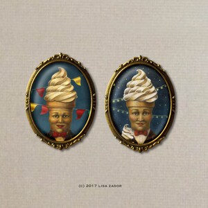 May include: Two oval-framed portraits feature whimsical figures with ice cream cone hats. One has colorful pennants, the other has string lights. Both figures wear bow ties and are set against a dark blue background. The frames are gold.