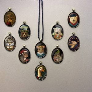 May include: A set of 10 oval-shaped ornaments featuring various animals wearing hats and clothing. The ornaments are made of metal and have a brown finish. The animals include a reindeer, a wolf, a squirrel, a goose, a polar bear, a mouse, a dog, and a bear.
