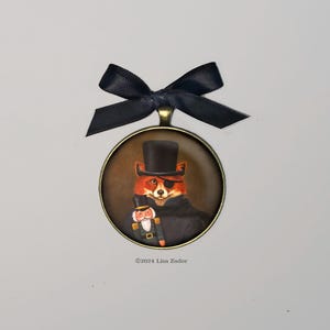 May include: A round, bronze-colored ornament with a black ribbon. The ornament features a painting of a fox wearing a top hat and an eye patch, holding a nutcracker.