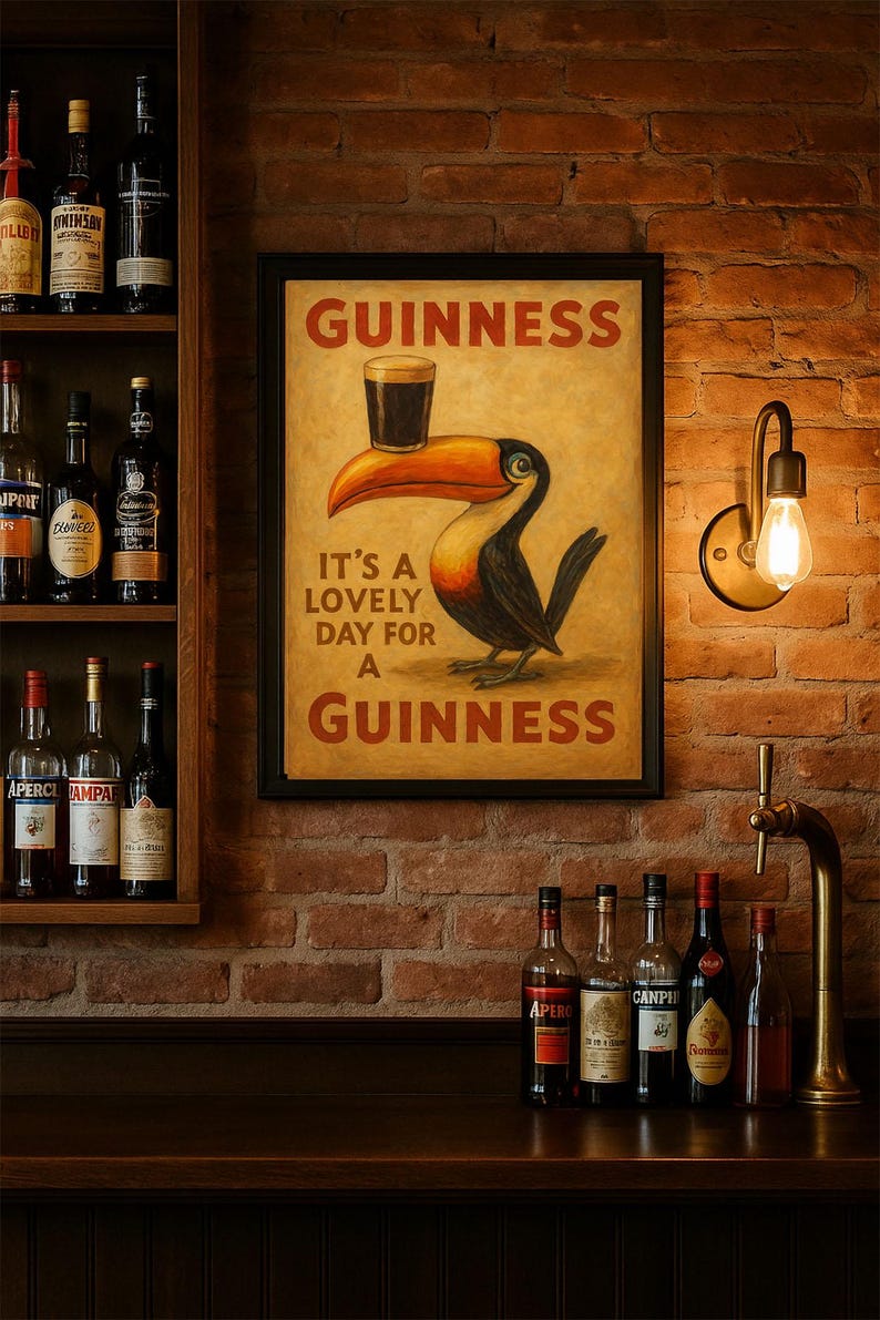 May include: A framed Guinness advertisement featuring a toucan with a pint of Guinness on its beak. The text reads "It's a lovely day for a Guinness." The image is set against a brick wall, with a shelf of liquor bottles.