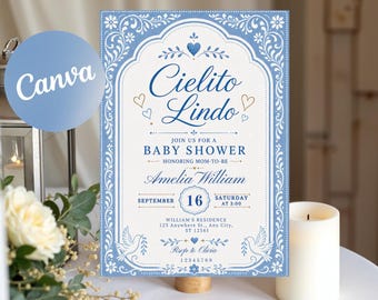 May include: A rectangular baby shower invitation card featuring a blue and white ornate border with floral motifs. The text reads Cielito Lindo, Join us for a baby shower honoring Amelia William, September 16, Saturday at 3:00, and RSVP to Olivia.