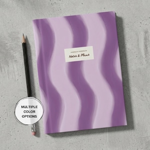 May include: A notebook with a lavender and purple wavy design. The notebook features the text "Notes & Plans" and "Madison Anderson" on a rectangular label. A black pencil and a white circle with the text "MULTIPLE COLOUR OPTIONS" are also in the image.