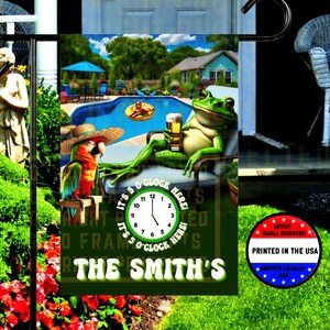 May include: A garden flag featuring a cartoon frog relaxing with a beer by a pool, with a parrot. The flag reads "It's 5 O'Clock Here" and "The Smith's". Includes a "Printed in the USA" seal.