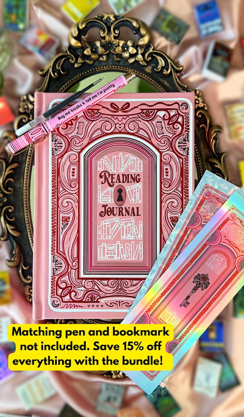 May include: A pink reading journal with an elaborate cover design, featuring the words "READING JOURNAL". A matching pink pen with the text "Buy me books & tell me I'm pretty" and a bookmark are also visible.