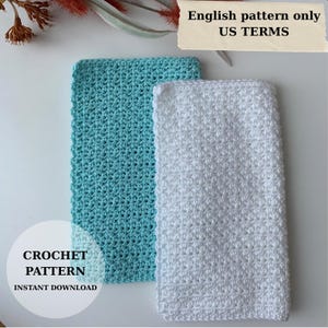 May include: Two rectangular crochet washcloths, one in light turquoise and one in white, featuring a textured stitch pattern. A paper label at the top reads English pattern only US TERMS, and a circular graphic reads CROCHET PATTERN INSTANT DOWNLOAD.