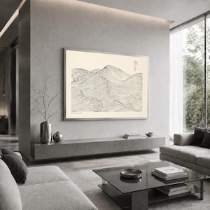 May include: A rectangular wall art print featuring a black line drawing of rolling hills or waves on a cream background. The artwork includes small red text in the upper right corner and black text in the lower left corner, framed in silver.