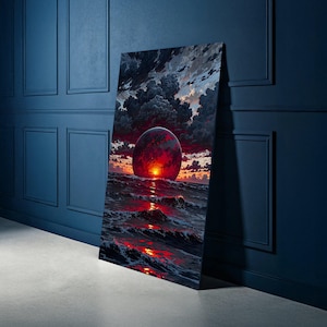 May include: A large rectangular canvas print showing a dramatic seascape with a fiery red orb setting over the ocean. The sky is filled with dark, ominous clouds, and the waves reflect the vibrant sunset colours. The artwork is leaning against a dark blue wall.